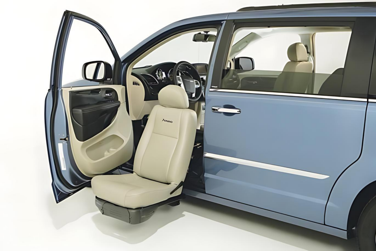 A blue minivan with one of its doors open displays a front passenger seat that can pivot and extend outside the vehicle.