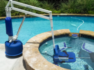 A pool lift with the seat submerged in water.