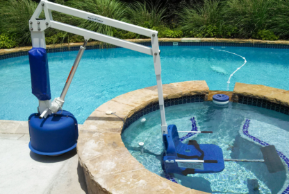 A pool lift with the seat submerged in water.