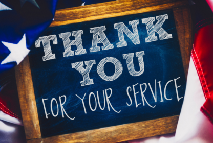 A chalkboard sign with the message "Thank You for Your Service" surrounded by an American flag.