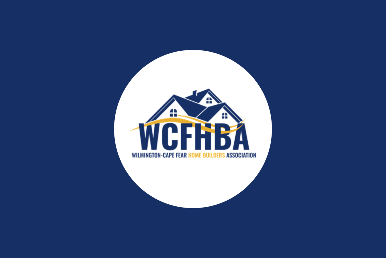 Logo of Wilmington-Cape Fear Home Builders Association with a house and sun above "WCFHBA" in blue letters and "Home Builders Association" in orange text below. Blue background with white circle.