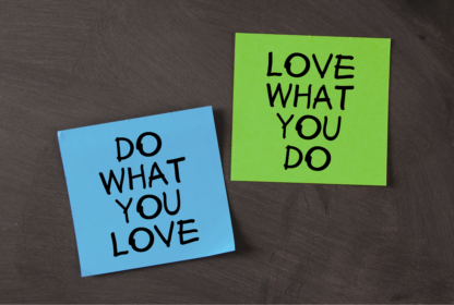 Two sticky notes on a dark surface; one blue note says "DO WHAT YOU LOVE" and one green note says "LOVE WHAT YOU DO.