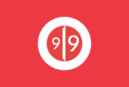 A red circular logo with white borders featuring the numbers 9 and 9 separated by a vertical line in the center.