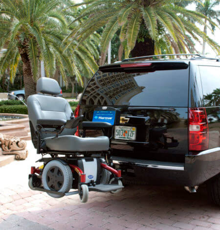 Wheelchair carrier attached to a black Chevy