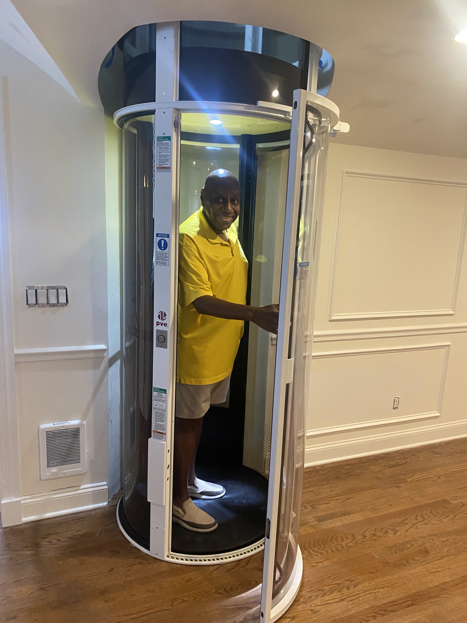 man standing inside an at home elevator