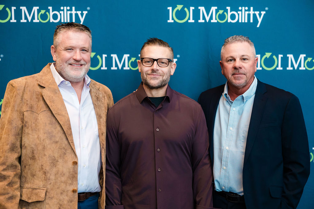 Michel Ragland (center) is awarded the prestigious Royce Barnhardt Excellence Award, joined by 101 Mobility co-founders Luke Sampson (left) and Keith Barnhardt (right).