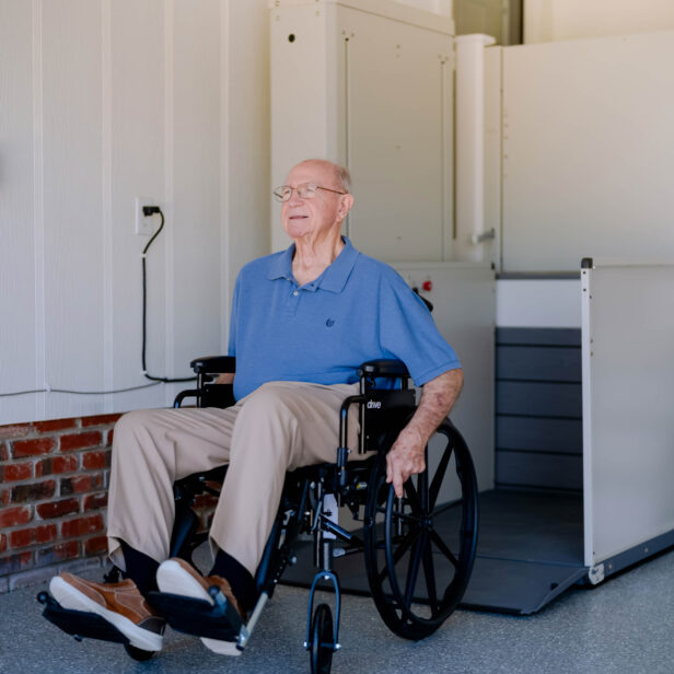 a man on a wheelchair using a Bruno vertical platform lift.