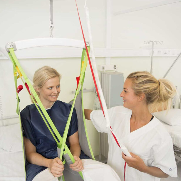 a patient using a human care overhead patient lift.