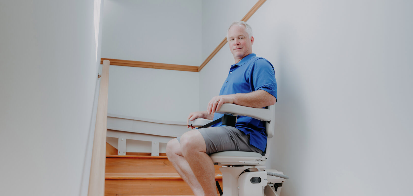 a man using a curved stairlift.