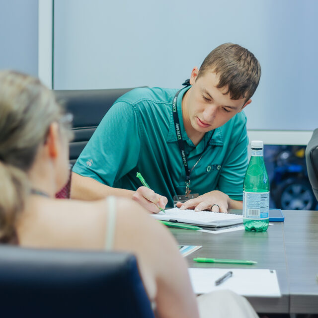 A person taking notes.