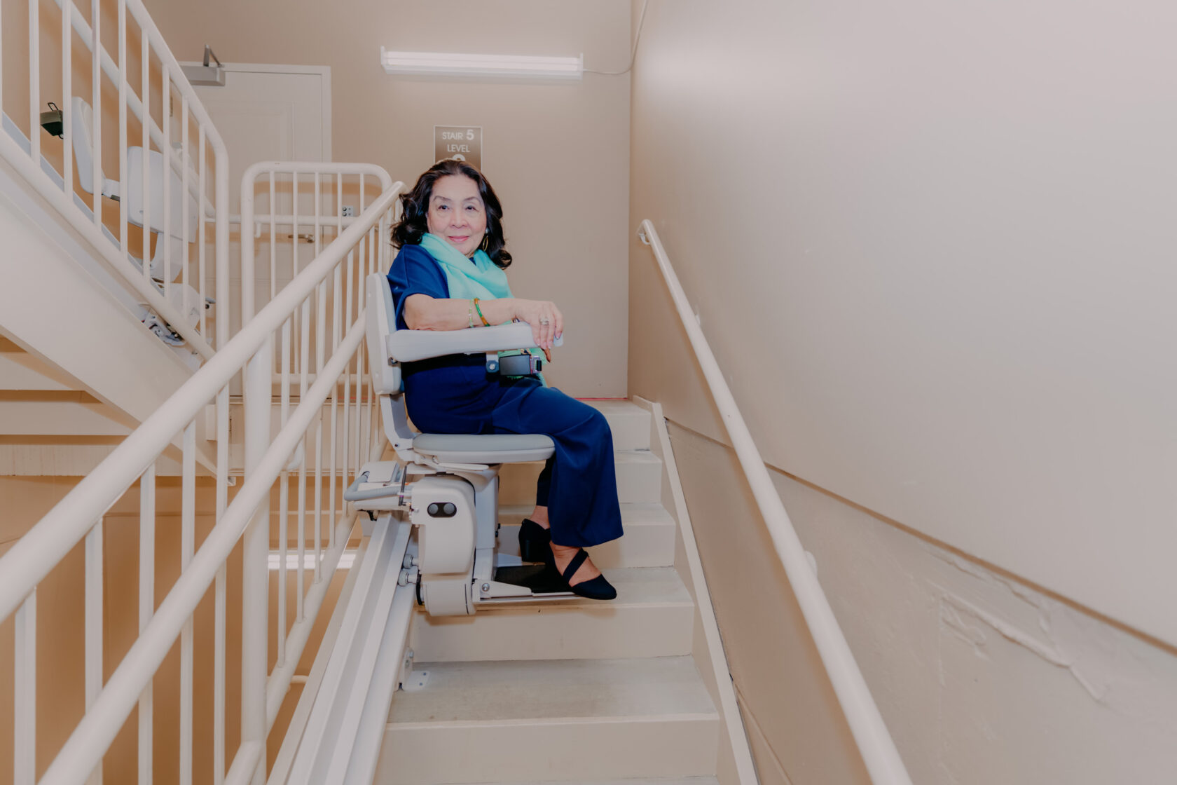 a woman using a stairlift.