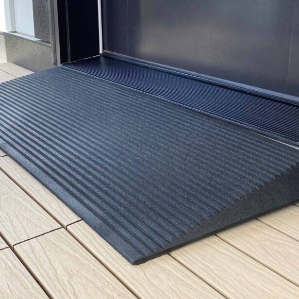 a close up view of a rubber threshold ramp.