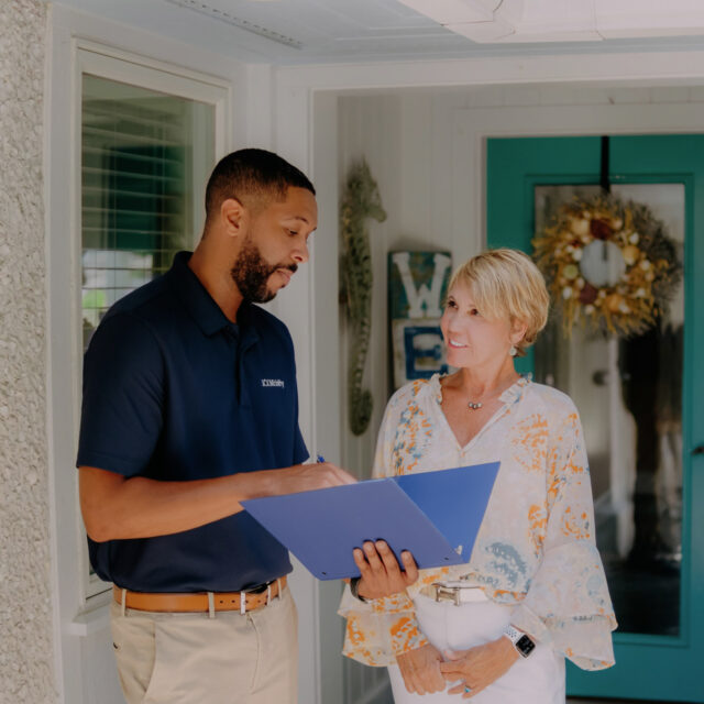 A 101 mobility team member having a conversation with a person.