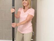 a woman using a stander pole.