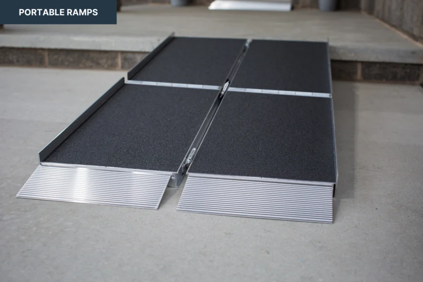 Portable ramps laid out on a concrete surface, near a raised step.